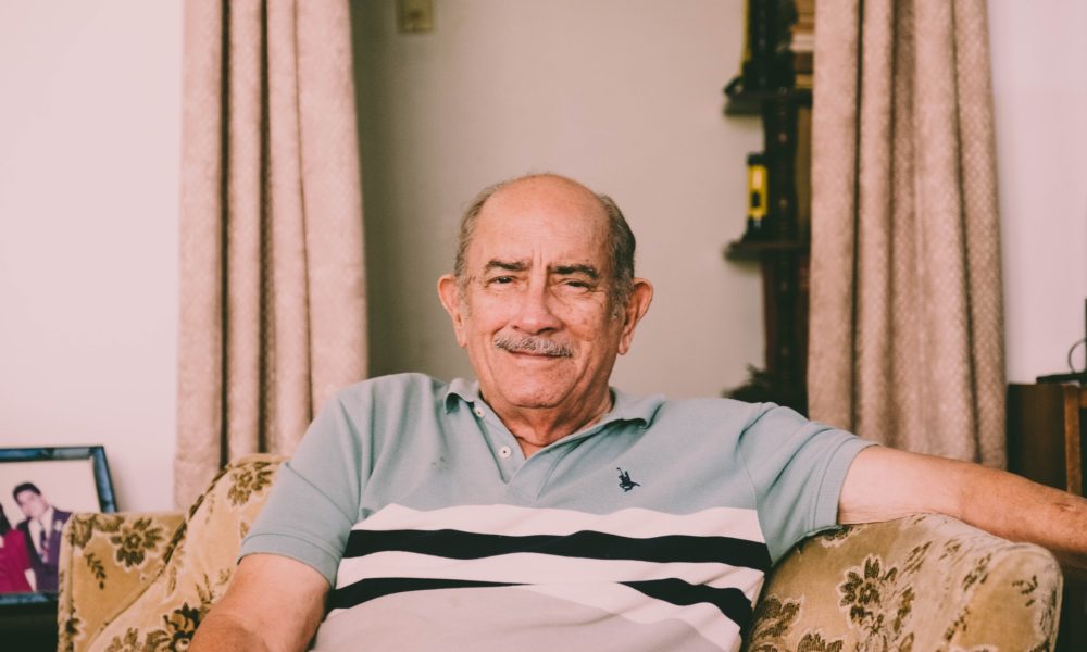 Elderly man sitting on a couch