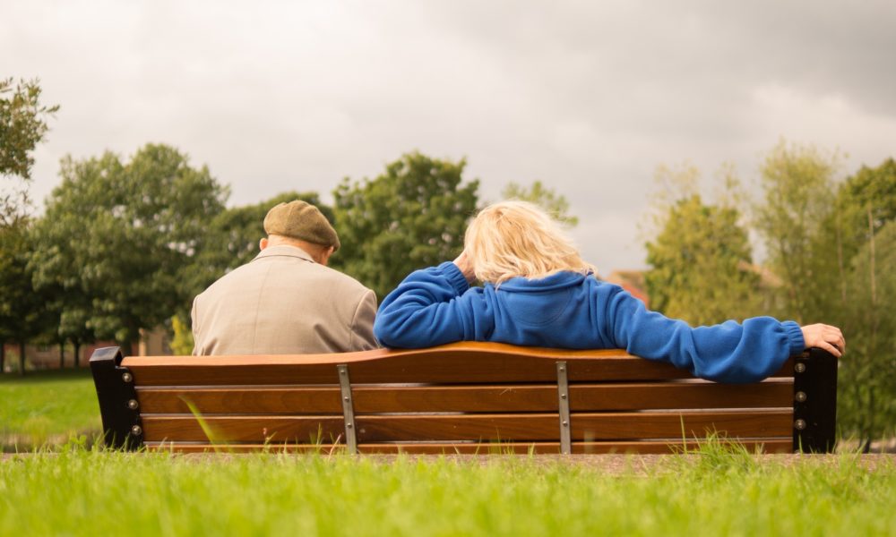 an older gentleman on a bench with a woman