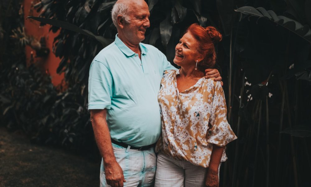 older couple standing happily together