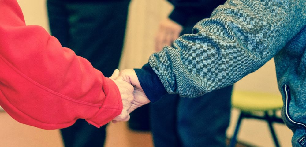 Missouri essential caregivers: two seniors hold hands
