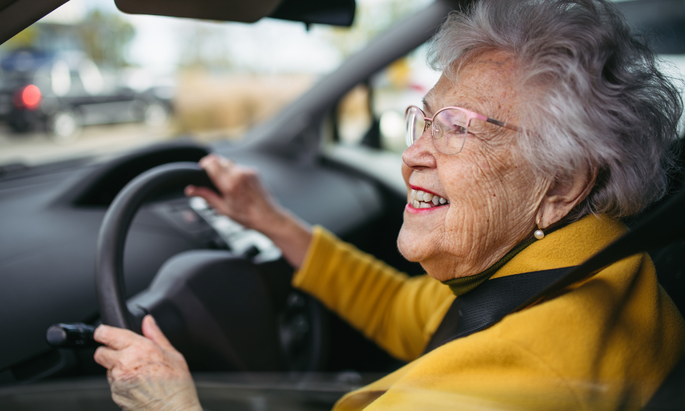 woman smiles while behind the wheel