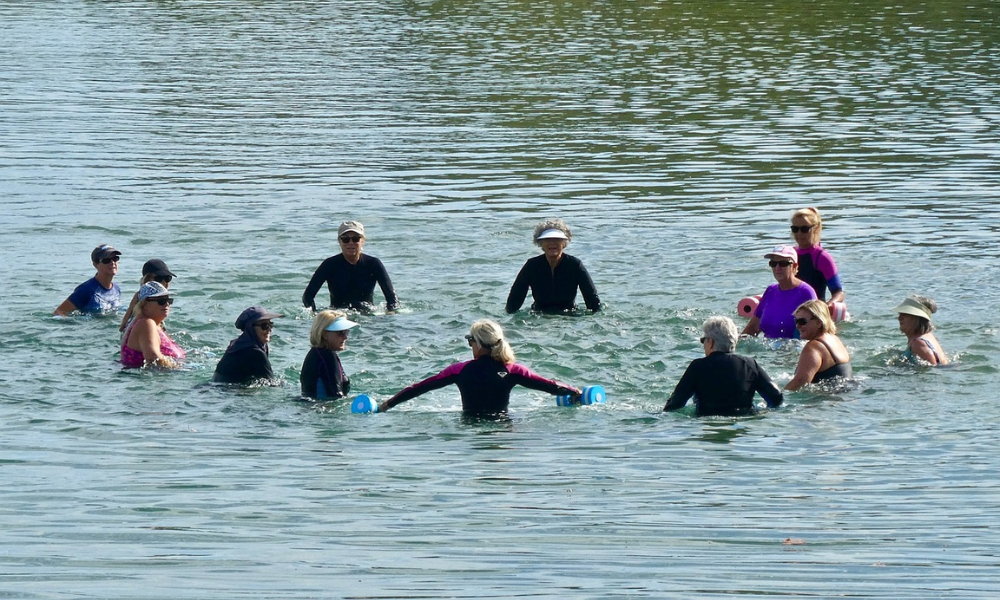 group swimming and exercising in a lake together